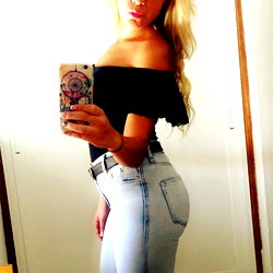 Stylish Onlyfans Model Showcasing Casual Look with Jeans and Ripped Tights