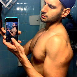 Strong and Shirtless Model Tomi Posing in Bathroom Mirror