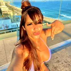 Alle Salomão on a rooftop overlooking the ocean