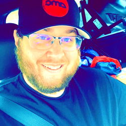 Smiling Man in a Truck with an AMO Hat