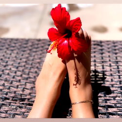 Foot with a Red Flower Nestled in the Toes