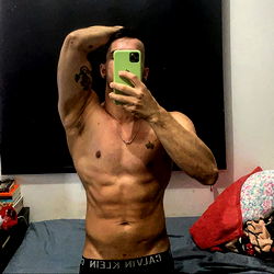 Acroboy Showcasing Physique in Gym