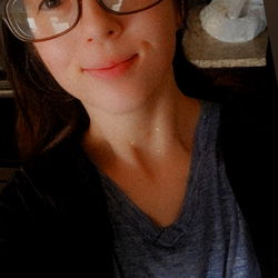 Young Woman with Glasses and Cat, Standing in Kitchen