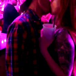 Intimate Couple Sharing a Kiss in the Club
