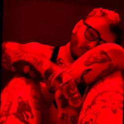 A Tattooed Model in a Red Lightroom