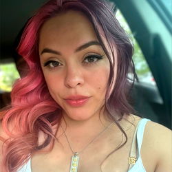 Vivid-haired model in car interior