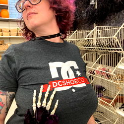 Model with DC Shoes t-shirt and skull necklace in a store aisle