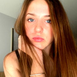 Young Adult Woman with Red Hair and Blue Eyes