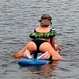 Kelly, a swimsuit model posing with a kayak