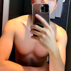 Shirtless Fitness Model Arran with Smartphone in Hand, Sharing a Mirror Selfie