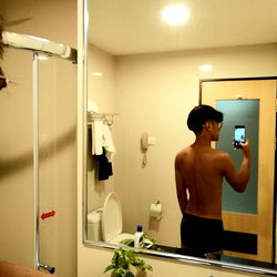 A Model Posing in a Bathroom Mirror