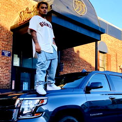 Yuhhh, a Rapper from Cleveland, OH, Posing on Top of a Car