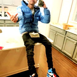 Young Man in Hoodie Sitting on Counter