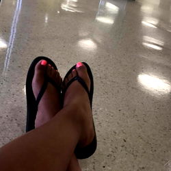Model Angelbaby Relaxing in Waiting Area with Flip-Flops