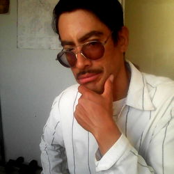 Thoughtful Man in White Shirt and Sunglasses