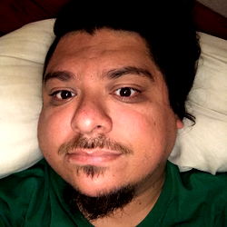 Mike Honcho, an OnlyFans model photographed in a green shirt and glasses, sharing his story.