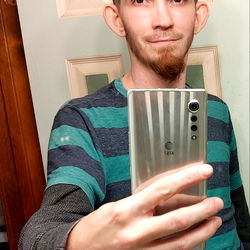 A young adult male taking a selfie