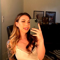 Aubs, a tattooed model posing for the camera