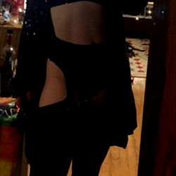 Model in a Lingerie-Inspired Shirt Standing Against a Mirror