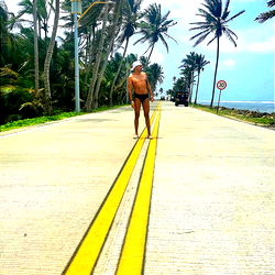 Beautiful Beachside Road with Zebra Crossing and Surfer