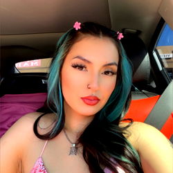 Sumndmor, an OnlyFans model showcasing her beauty in a pink dress