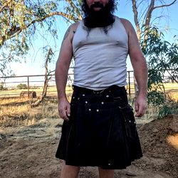 A Bearded Man in a Kilt, Standing Outdoors
