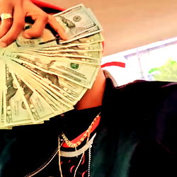 Caught in the act of counting cash with a hoodie and chains