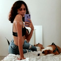 Young Woman with Short Hair, Jean Jacket and Ponytail, Taking a Selfie