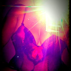 A Photograph of a Woman in Lingerie, Shot with a Focus on Her Torso and the OnlyFans Logo