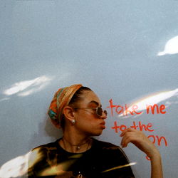 Female Model Phoenix Moon Standing Against Wall