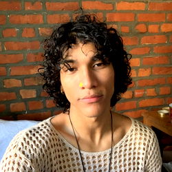 A candid portrait of Ken, a young adult male. He's posing for the camera with his signature style.