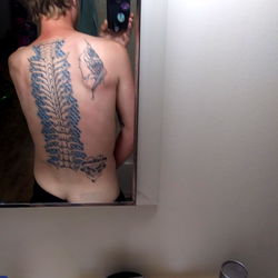 Tattooed Dreamer: A Model Showcasing His Back Tattoo