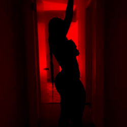 Model AshKatchem in a Dimly Lit Room