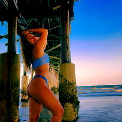 Amanda, a beautiful model striking a pose on the beach at sunset