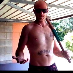 Shirtless Man Holding Hammer