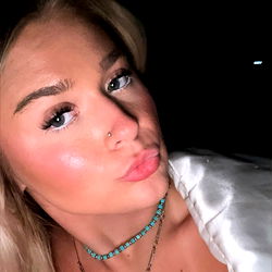 Blonde Model Smiling in Low Light, Necklace, Ring