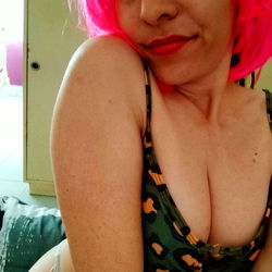 Onlyfans Model Posing in Lingerie with Pink Hair and Green Tank Top