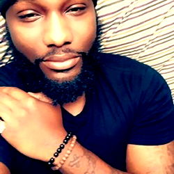 Saintbenzx, Rapper and Actor, Seen Here in a Playful Pose with His Hands behind Him