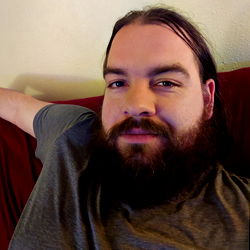 Bearded Man with Short Hair in Beige Sweater, Smiling