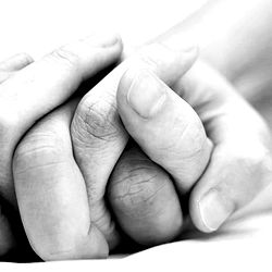 Close-up of hands clasped in prayer or blessing
