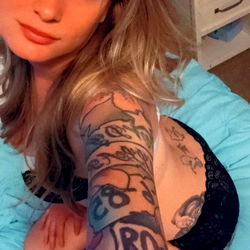 Kandy, the OnlyFans model from Nevada with a striking look, showcasing her tattoos and confident pose.