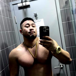 A Fitness Model Showcasing a Shirtless Physique in the Gym