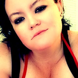 OnlyFans model LIONESS showcasing her busty physique with a seductive pose and inviting expression. Model is based in Florida.