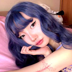 Natsumi, a captivating model from Kawai world with vibrant blue hair and striking eyeliner.