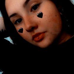 A young woman showcasing her piercing and tattoos