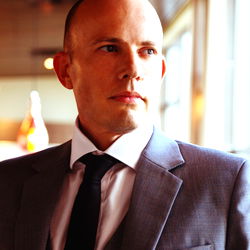 Man in Suit Posing for Photo