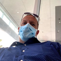 A Man in a Mask Sitting Down