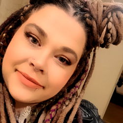 AlanaCox with vibrant hairstyle and piercing gaze