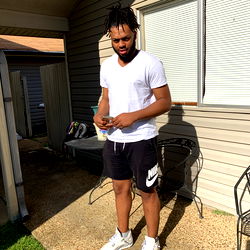 KJ, A Young Athlete in a White T-Shirt and Shorts, Outdoors