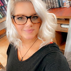 A young woman posing in a room with bookshelves, 2021. #KelliPearson #SouthCarolina